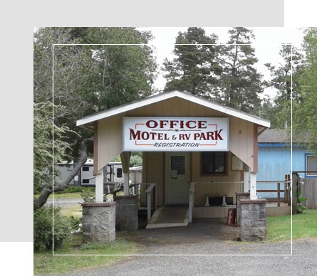 Sign for "Office Motel & RV Park Registration" on a building, surrounded by trees.